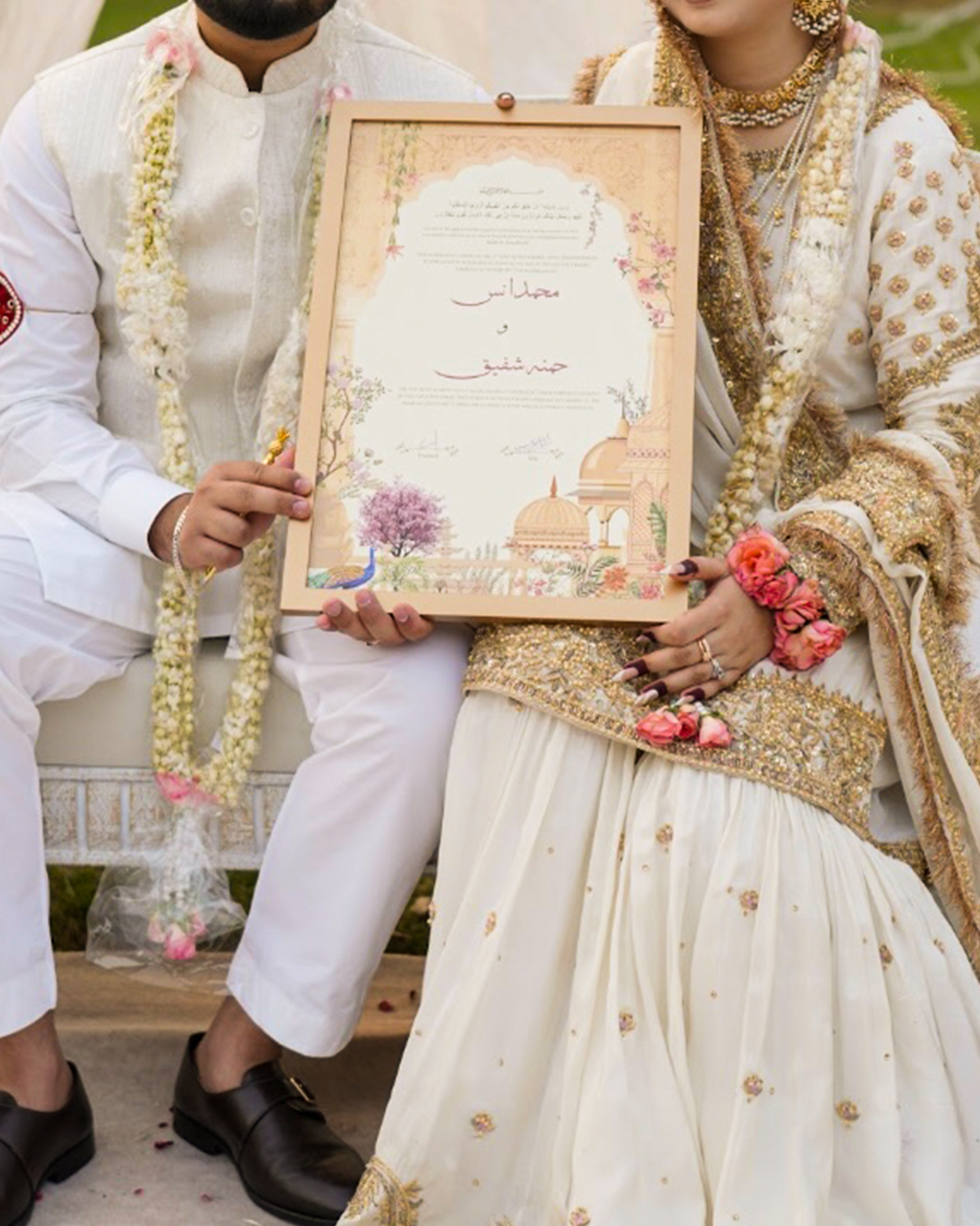 Bride and groom sitting on a decorated Nikah stage