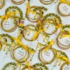 Bride and groom illustrated Mehndi favour cards with golden bangles