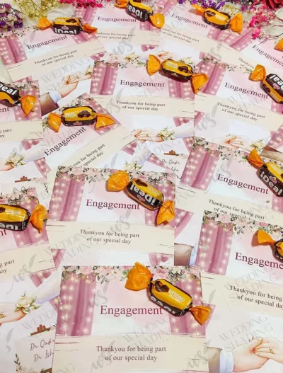 Chocolate candies attached to romantic engagement favour cards