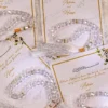 Close-up of clear prayer beads and white tassel on Nikkah card