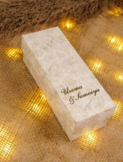 Close-up of floral Baat Paaki tag on sweet box