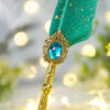 Magnificently ornate vintage golden centerpiece frame carrying an emerald crystal