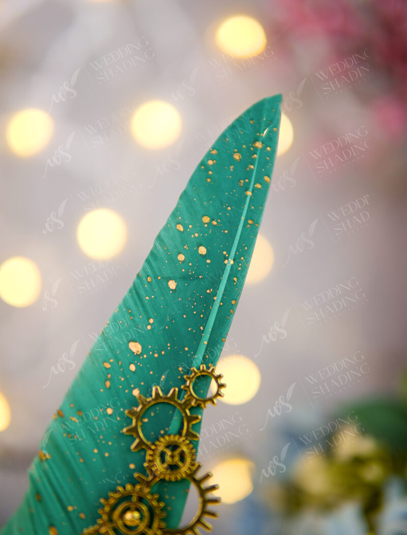 Vibrantly colored rich emerald green feather covered in golden specks