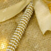 Brilliant pure white feather above gleaming golden calligraphy