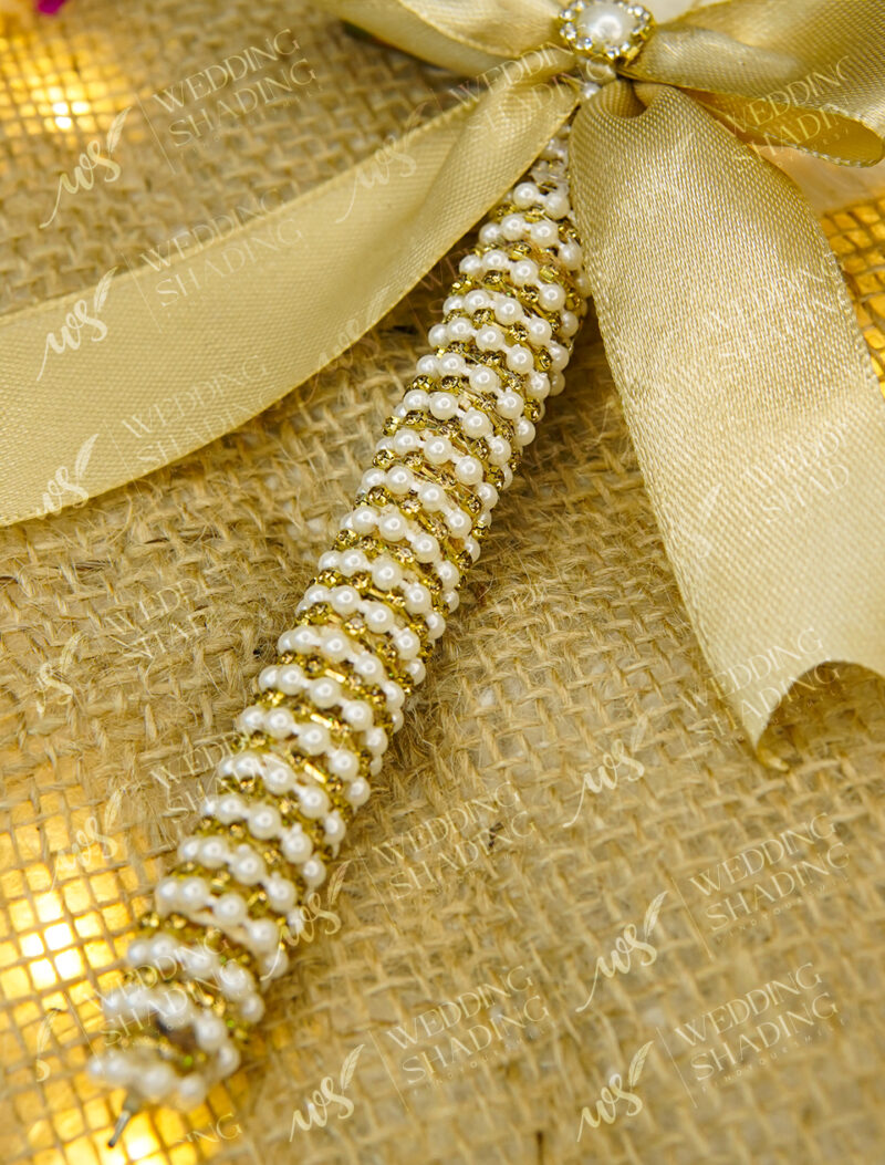 Brilliant pure white feather above gleaming golden calligraphy
