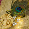 Close view of the hand-folded golden satin ribbon rose top