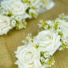 Close-up of pristine white artificial roses on bridal gajray