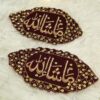 Close-up of intricate gold embroidery and heavy stonework border on deep maroon velvet Imam Zamin