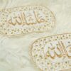 Close-up of intricate gold embroidery and heavy embellished border on white velvet Imam Zamin