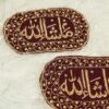 Close-up of rich gold thread embellishments and floral embroidery framing on dark black velvet Imam Zamin