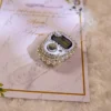Pearl and rhinestone tally counter on elegant wedding favour card
