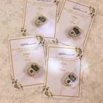Premium white and gold favour cards featuring pearl tally rings