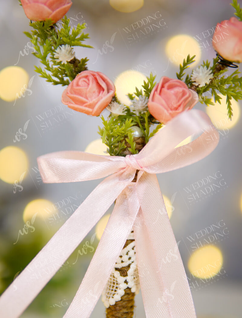 Close-up of the delicate pink roses and greenery on the heart wreath