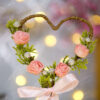 Beautiful pink satin bow at the base of the floral heart frame