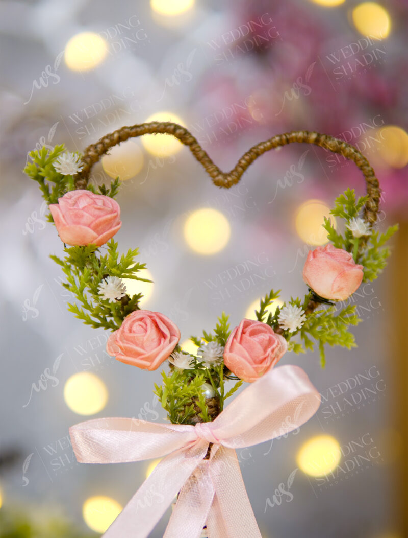 Beautiful pink satin bow at the base of the floral heart frame