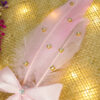 Close-up of the elegant pink satin bow and spiraling crystal handle