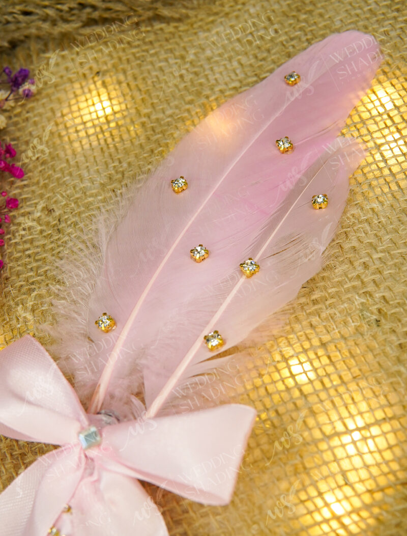 Close-up of the elegant pink satin bow and spiraling crystal handle