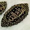 Close-up of intricate gold embroidery and sparkling stonework border on black velvet Imam Zamin