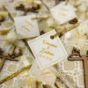 Close-up of laser-cut wooden Qubool Hai and white rose decoration
