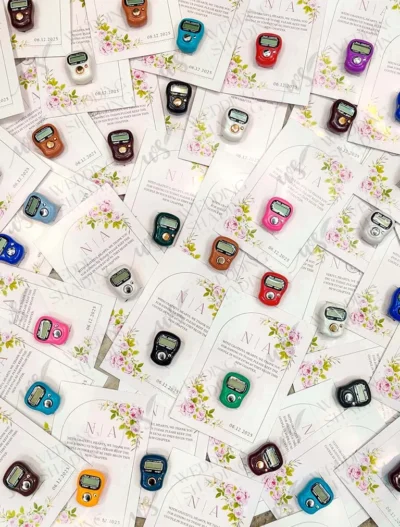 Close-up of digital tally counter on pink floral card