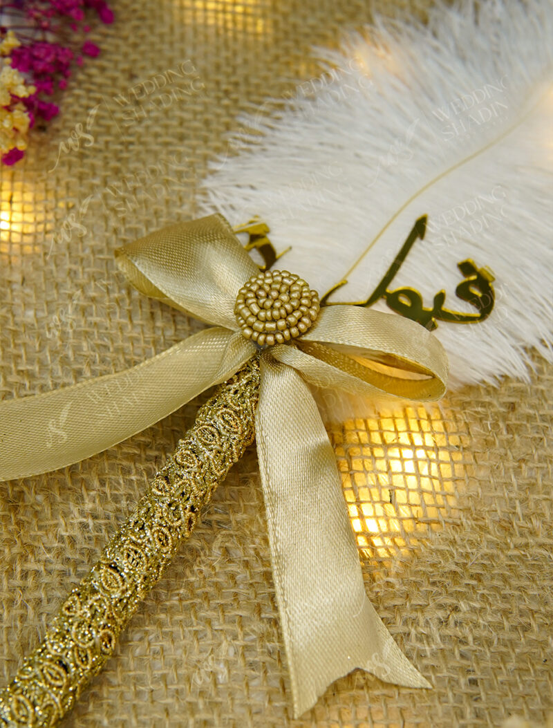 Golden satin bow centered with a textured golden focal bead