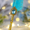 Detailed vintage textured golden handle and beautiful feather