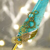 Beautiful golden metallic wing and steampunk gear details with blue gem