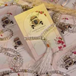 Close-up of floral vintage car design with clear prayer beads