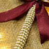 Stunning gold acrylic Qubool Hai calligraphy above a deep burgundy bow