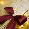 Elegant pearl and rhinestone center on the bow with cascading beads