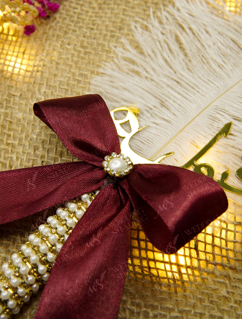 Elegant pearl and rhinestone center on the bow with cascading beads