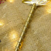 Close-up of the shimmering gold mesh handle dotted with rhinestones