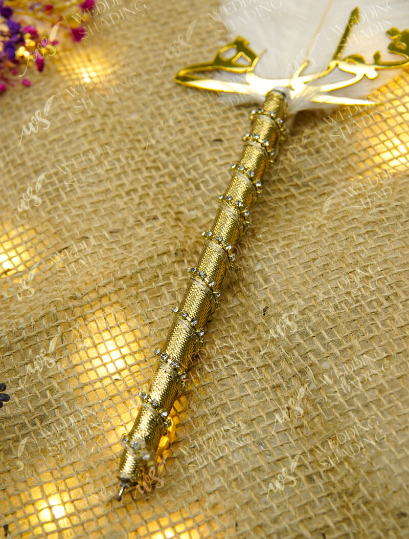 Close-up of the shimmering gold mesh handle dotted with rhinestones