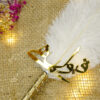 Beautiful golden Qubool Hai calligraphy piece resting on white feather