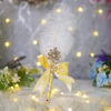 Golden satin ribbon handle close-up with pearl cluster and red gem detail