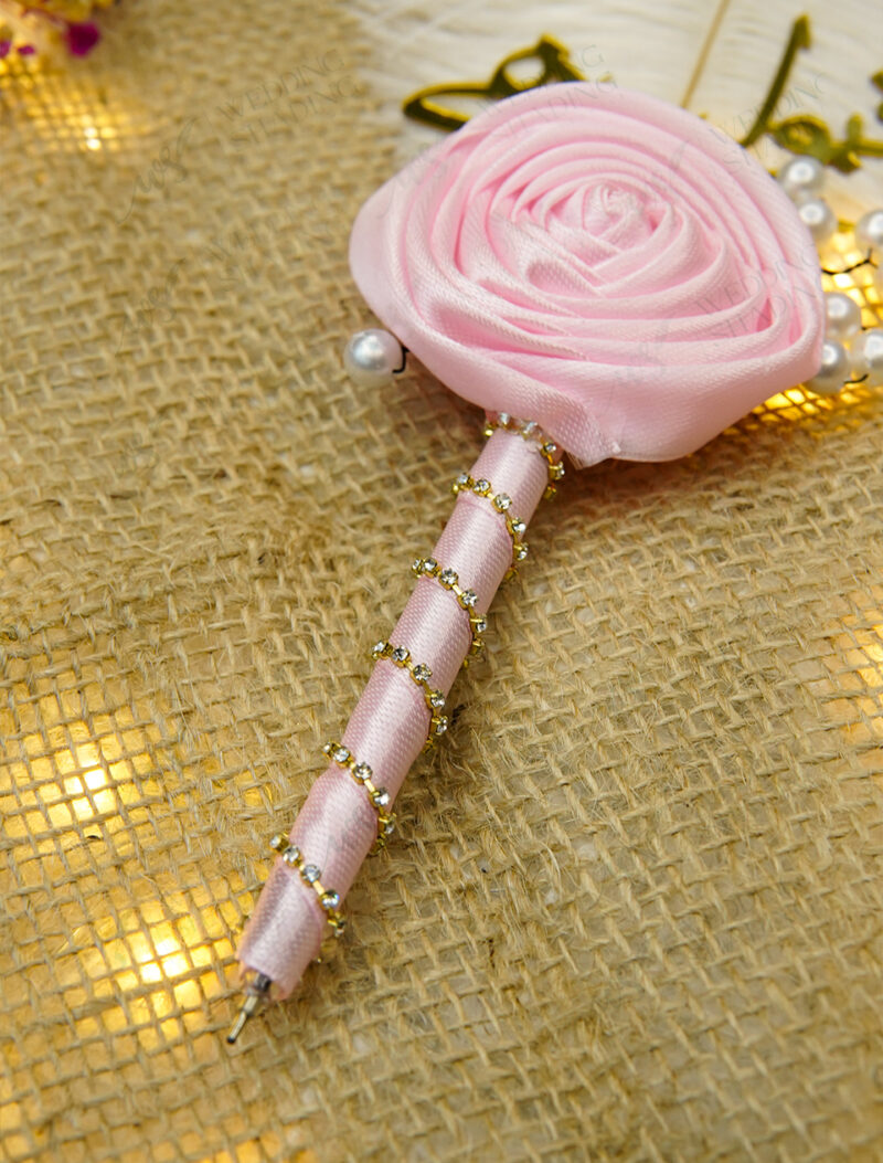 Elegant pink satin wrapped handle with spiraling rhinestone crystals