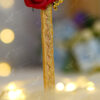 Deep red folded satin roses with pearls and golden calligraphy
