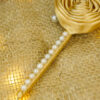 Gold satin ribbon covered handle adorned with a row of beautiful pearls