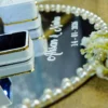 Side angle of pink rose ring tray showing pearl and rhinestone edge