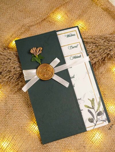 Close-up of olive branch watercolor design on cream wedding card