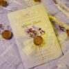 Lavender floral wedding card with white organza ribbon and gold wax seal