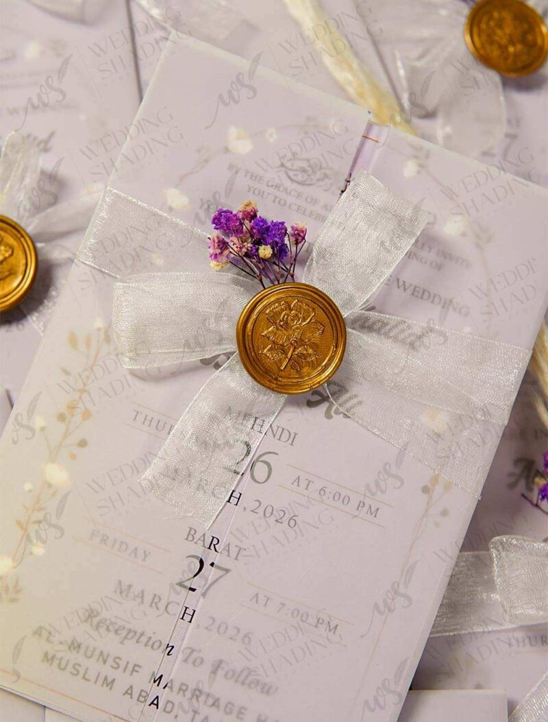 Multiple lavender wedding cards arranged showing vellum wraps