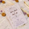 Full invitation set with vellum overlay, ribbon, seal, and flowers