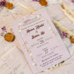 Full invitation set with vellum overlay, ribbon, seal, and flowers