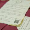 Premium cream card with gold foil text and deckled torn edges
