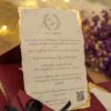Detailed view of hand-tied black ribbon on maroon wedding card envelope
