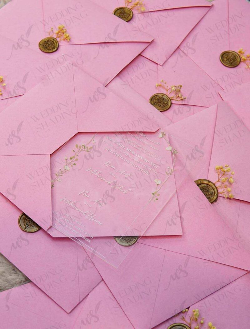 Close-up of white UV-printed text on transparent acrylic invitation