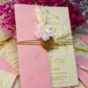 Full set view of the pink envelope, cream card, and wax seal