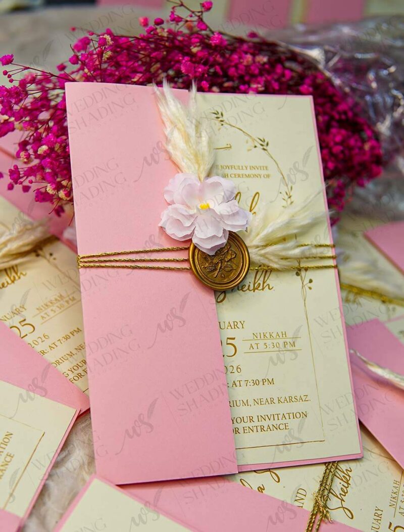 Full set view of the pink envelope, cream card, and wax seal