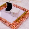 Ring boxes displayed on the pink pearl frame tray (boxes sold separately)